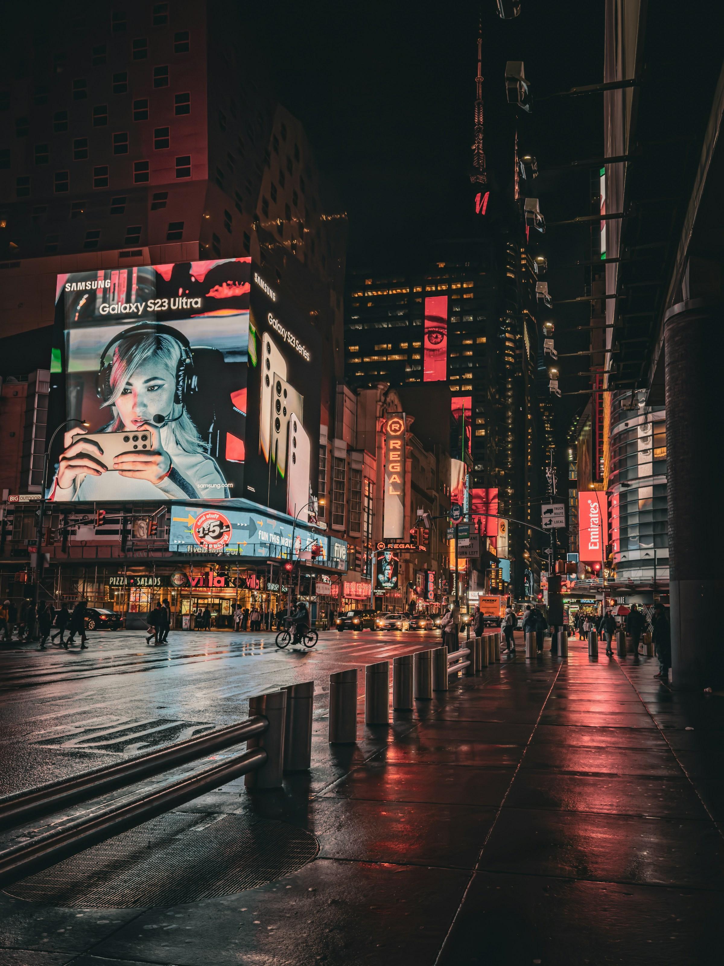 Illuminated advertising screens in a city at night