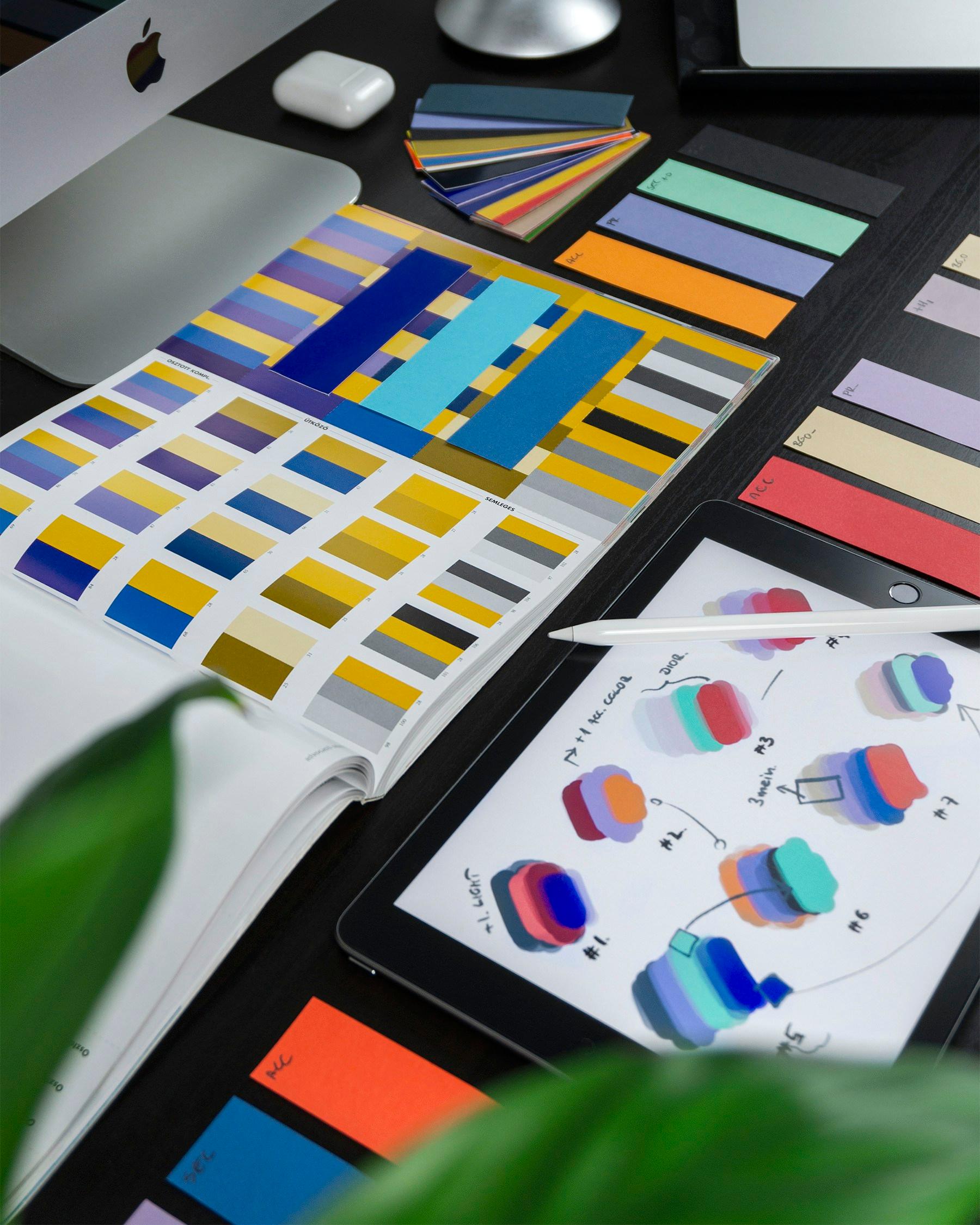 Color swatches and interface sketches on a designer's desk