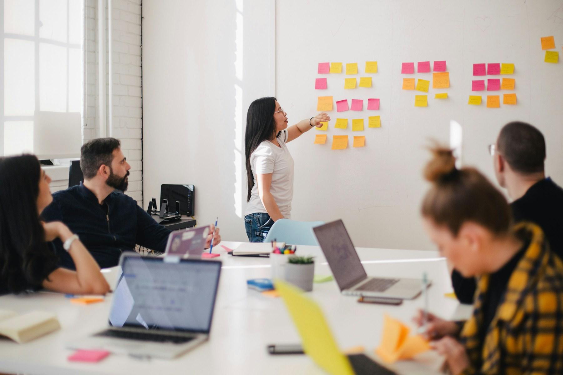 Creative collaborators reviewing advertising design work across a studio table